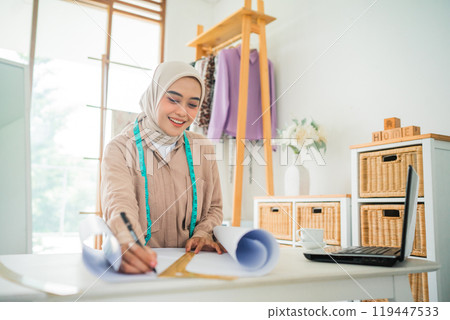 A Creative Young Designer Engaged at Work in a Chic, Modern Home Studio Environment 119447533