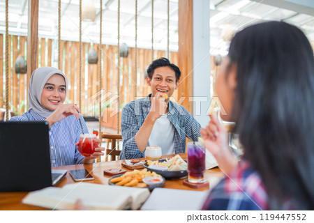 male and female university students break fast together in a coffee shop male and female university students break fast together in a coffee shop 119447552