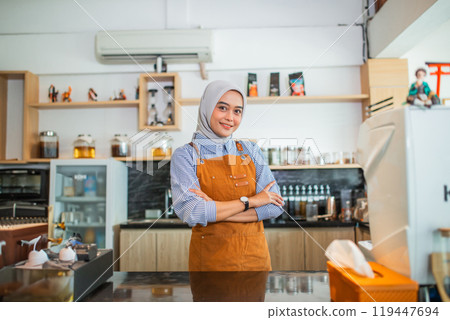 beautiful woman in hijab cafe owner wearing apron standing in coffee cafe 119447694