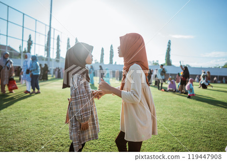 Joyful Moments: Two Young Girls Engaging in Playful Interaction Outdoors Joyful Moments: Two Young Girls Engaging in Playful Interaction Outdoors 119447908