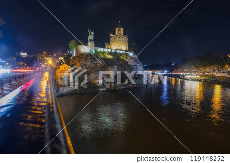 Night view over the Kura River in Tbilisi, Georgia, with city lights reflecting on the water 119448252