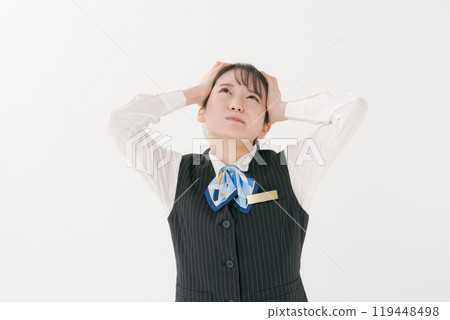 A woman in office clothes holding her head A woman in office clothes holding her head 119448498