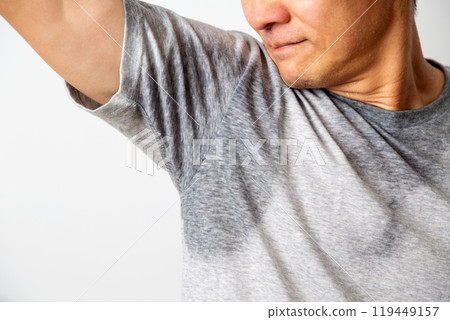 Middle-aged man smelling his sweaty T-shirt Middle-aged man smelling his sweaty T-shirt 119449157
