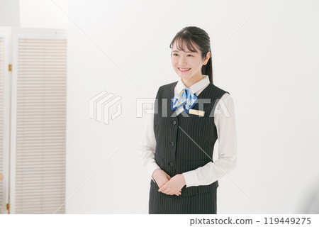 A woman in her 20s wearing a company uniform 119449275