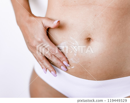 Nourishing skincare routine highlighting hydrated female belly 119449329