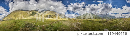 Scenic view of the Cross Pass in Georgia, showcasing lush green mountains and a winding valley 119449656
