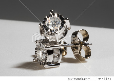 Diamond earrings. Big diamond earrings, large solitaire earrings on white background. Diamond earrings. Big diamond earrings, large solitaire earrings on white background. 119451134