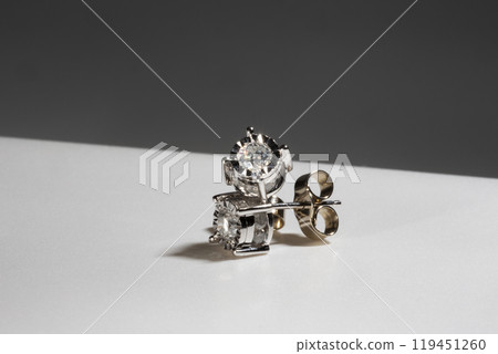 Diamond earrings. Big diamond earrings, large solitaire earrings on white background. Diamond earrings. Big diamond earrings, large solitaire earrings on white background. 119451260