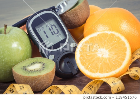 Glucose meter for checking sugar level, fresh fruits and orange juice Glucose meter for checking sugar level, fresh fruits and orange juice 119451576