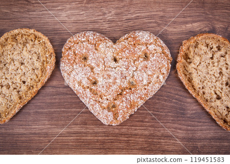 Bread in shape of heart baked from whole grain flour 119451583