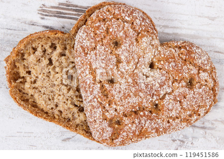 Bread in shape of heart baked from whole grain flour 119451586