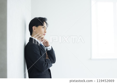 A thoughtful young businessman A thoughtful young businessman 119452669
