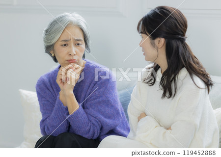 A senior woman and a young woman arguing in the living room A senior woman and a young woman arguing in the living room 119452888