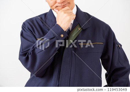 A middle-aged male businessman in work clothes who is worried A middle-aged male businessman in work clothes who is worried 119453049
