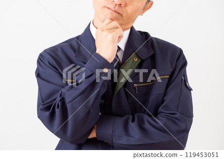 A middle-aged male businessman in work clothes who is worried A middle-aged male businessman in work clothes who is worried 119453051