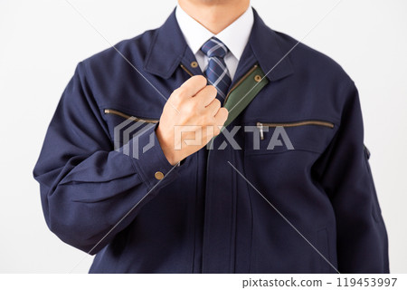 A middle-aged male businessman in work clothes making a fist-pumping gesture 119453997