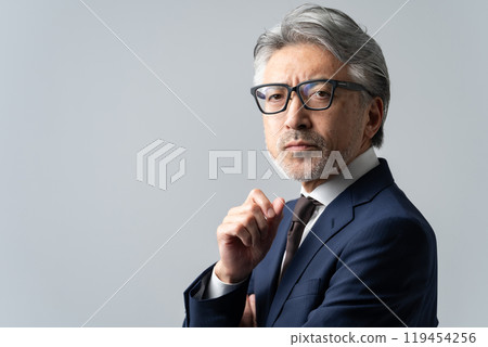 Businessman worried about gray hair 119454256