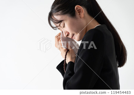 Young woman in mourning clothes crying Young woman in mourning clothes crying 119454483