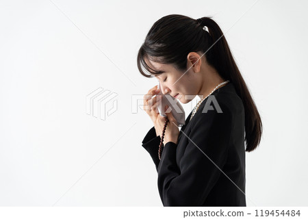 Young woman in mourning clothes crying Young woman in mourning clothes crying 119454484
