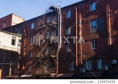 industrial architectural background, vintage buildings of an old factory industrial architectural background, vintage buildings of an old factory 119455439