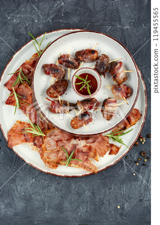 A plate of bacon wrapped dates. A plate of bacon wrapped dates. 119455565