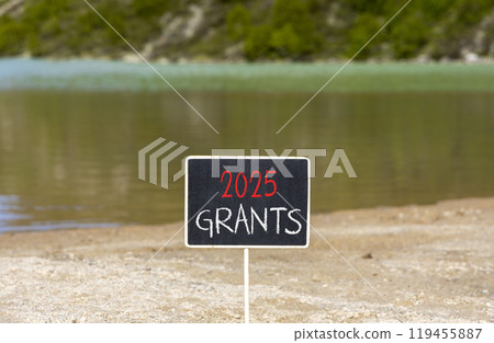 Planning 2025 grants new year symbol. Concept words 2025 Grants on beautiful yellow chalk blackboard. Beautiful mountain lake sand beach background. Business 2025 grants new year concept. Copy space. Planning 2025 grants new year symbol. Concept words 2025 Grants on beautiful yellow chalk blackboard. Beautiful mountain lake sand beach background. Business 2025 grants new year concept. Copy space. 119455887