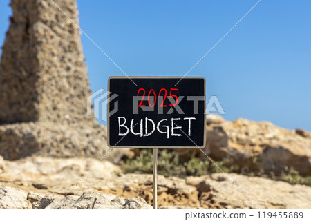 Planning 2025 budget new year symbol. Concept words 2025 Budget on beautiful yellow chalk blackboard. Beautiful stone beach blue sky background. Business 2025 budget new year concept. Copy space. Planning 2025 budget new year symbol. Concept words 2025 Budget on beautiful yellow chalk blackboard. Beautiful stone beach blue sky background. Business 2025 budget new year concept. Copy space. 119455889