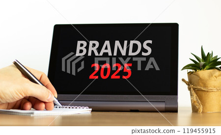 Planning brands 2025 new year symbol. Concept words Brands 2025 on beautiful black tablet. Beautiful white background. Businessman hand. Business brands 2025 new year concept. Copy space. Planning brands 2025 new year symbol. Concept words Brands 2025 on beautiful black tablet. Beautiful white background. Businessman hand. Business brands 2025 new year concept. Copy space. 119455915