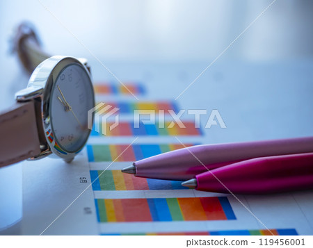 Graph and watch on a table Graph and watch on a table 119456001