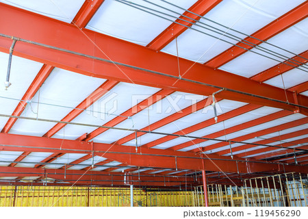 In interior of warehouse, construction is underway on large room for during reconstruction 119456290