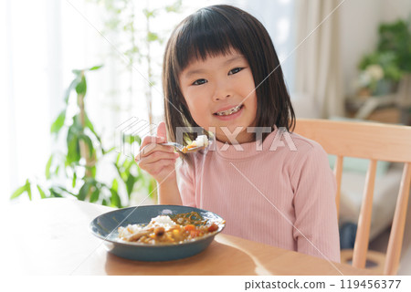 Child eating curry rice Child eating curry rice 119456377