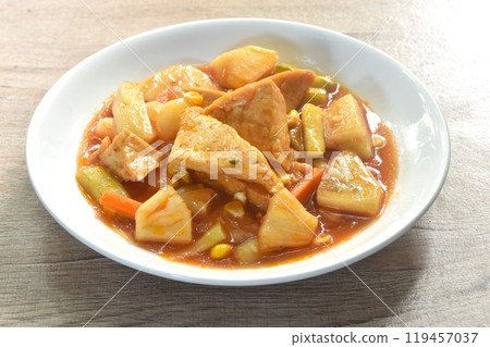 fried tofu with mixed vegetable in sweet and sour gravy sauce vegetarian food on plate  119457037