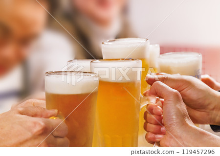 People toasting with ice-cold beer and sour drinks 119457296