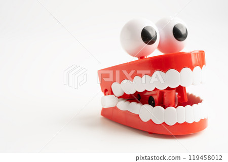 Tooth funny toy denture red color jaw and eye on white background with copy space. 119458012