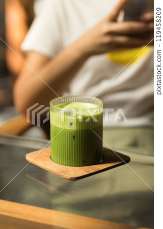 Enjoy a refreshing Iced Matcha Green Tea, perfect for a hot day. 119458209