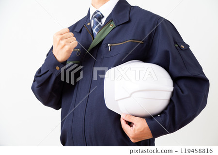 A middle-aged male businessman in work clothes making a fist-pumping gesture A middle-aged male businessman in work clothes making a fist-pumping gesture 119458816