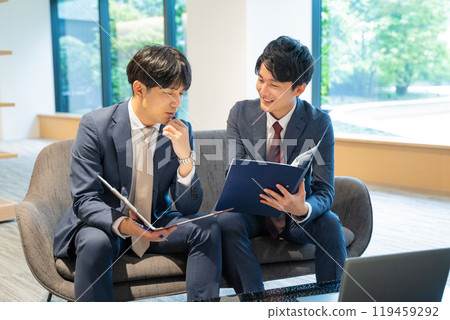 Two male businessmen having a meeting 119459292