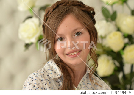 Pretty little girl smiling and posing with flowers 119459469