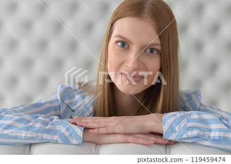 Beauty portrait. Young woman on grey wall background. Beauty portrait. Young woman on grey wall background. 119459474