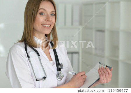 Young female doctor posing in the office Young female doctor posing in the office 119459477
