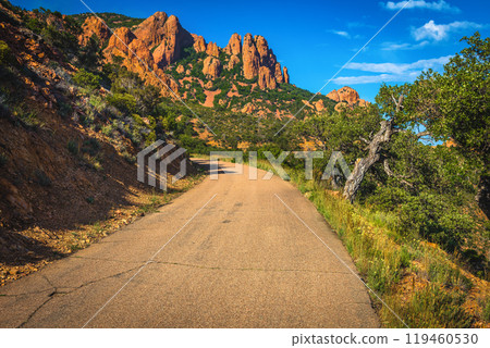 Narrow road and red rocks in the Esterel massif, France 119460530