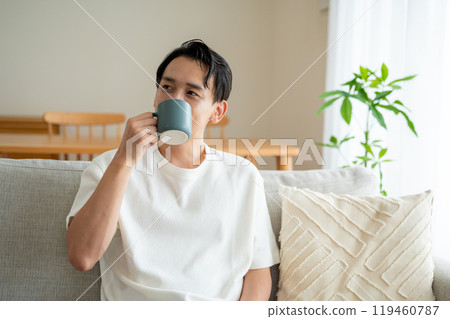 A man in his 30s drinking coffee A man in his 30s drinking coffee 119460787