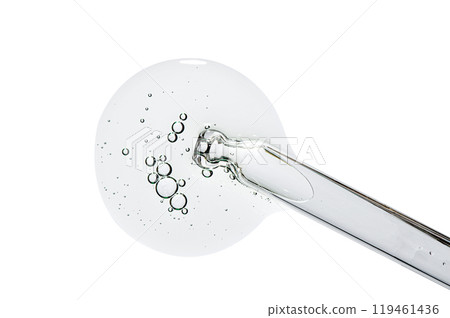 Pipette and a drop of cosmetic serum for the skin. Liquid body care product. Macrophotography. Isolated on a white background. Pipette and a drop of cosmetic serum for the skin. Liquid body care product. Macrophotography. Isolated on a white background. 119461436