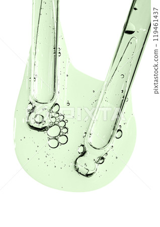 Two pipettes and a drop of cosmetic serum for the skin. Liquid body care product. Macrophotography. Isolated on a white background. Two pipettes and a drop of cosmetic serum for the skin. Liquid body care product. Macrophotography. Isolated on a white background. 119461437