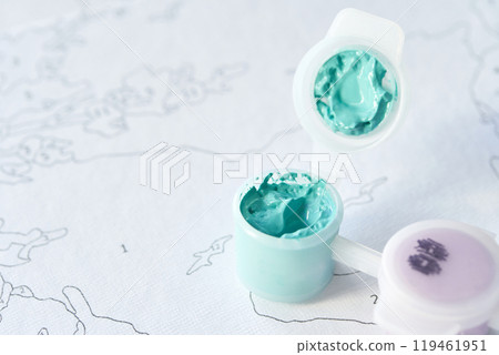 Close-up of blue paint in plastic containers on a paint-by-numbers canvas Close-up of blue paint in plastic containers on a paint-by-numbers canvas 119461951