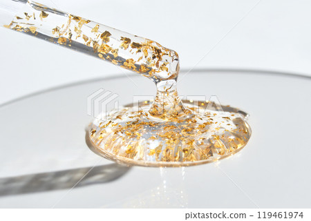 Luxurious translucent serum with gold flakes in dropper for premium skincare Luxurious translucent serum with gold flakes in dropper for premium skincare 119461974