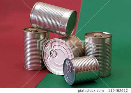A Group of Stacked Tin Cans on Split Red and Green Background A Group of Stacked Tin Cans on Split Red and Green Background 119462612