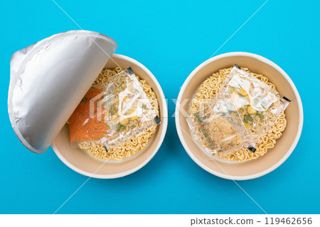 Opened Package with Uncooked Instant Noodles on Blue Background 119462656