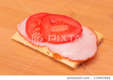 Whole Grain Crispbread with Tomato, Ham and Cheese Whole Grain Crispbread with Tomato, Ham and Cheese 119463668