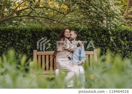 Happy loving couple enjoying their time together in park. Loving couple spending time together. Girl with tattoos. Tattooed woman. Beautiful fashionable couple of lovers on the street. Happy loving couple enjoying their time together in park. Loving couple spending time together. Girl with tattoos. Tattooed woman. Beautiful fashionable couple of lovers on the street. 119464016